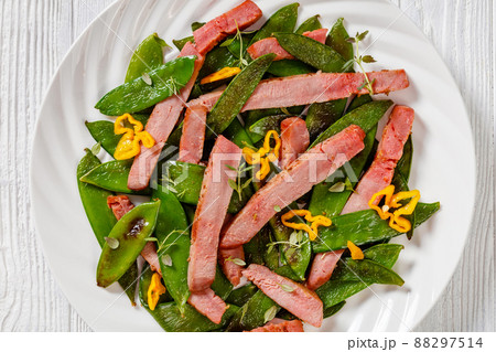 fried sugar snap peas with tuna slices 88297514