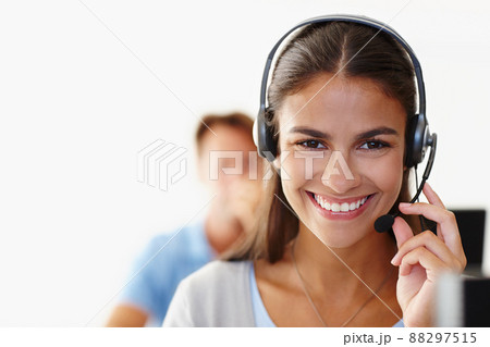 How can I help you today. Closeup of an attractive young woman using a headset. How can I help you today. Closeup of an attractive young woman using a headset. 88297515