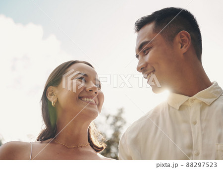 My favourite days are the days with you. Shot of a happy young couple standing outside together during the day. 88297523