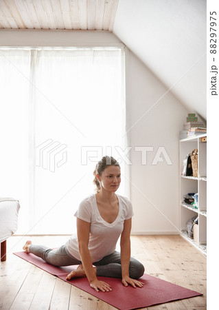 Yoga@home. Shot of an attractive young woman doing yoga at home. Yoga@home. Shot of an attractive young woman doing yoga at home. 88297975