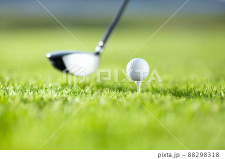 The first drive is vital. A golf club about to tee-off with a white ball on a golf course. 88298318