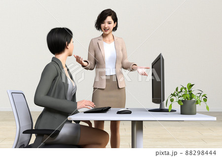 パソコン作業をしている女性社員に話しかける笑顔のビジネスウーマン 88298444