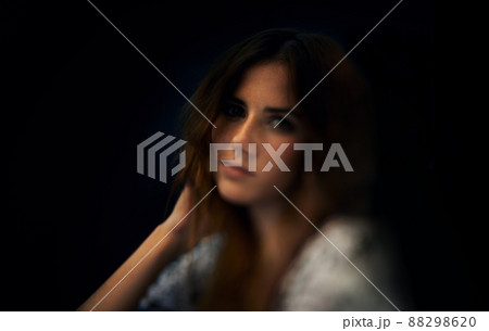 Femininity and style. A gorgeous young woman against a dark background. Femininity and style. A gorgeous young woman against a dark background. 88298620