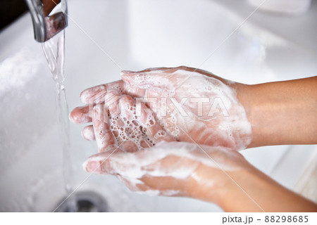 Good hygiene - a great habit. A cropped shot of a young woman washing her hands in her bathroom. 88298685