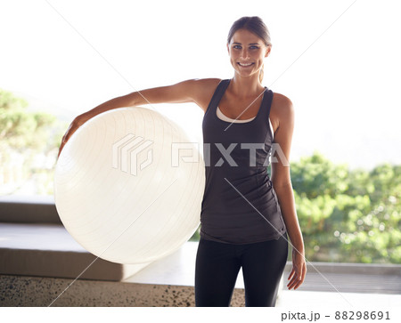 The only equipment I need for a good workout. Portrait of an attractive young woman holding an exercise ball. 88298691