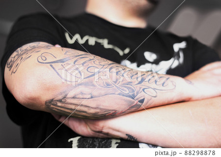 Badass with tattoos. Closeup shot of a man crossing his tattooed arms. Badass with tattoos. Closeup shot of a man crossing his tattooed arms. 88298878