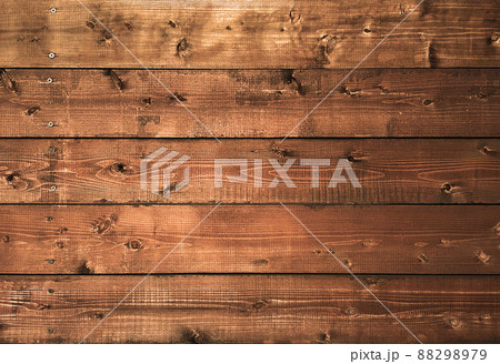 木目や節のある赤褐色の板壁の横長の背景画像 木目や節のある赤褐色の板壁の横長の背景画像 88298979