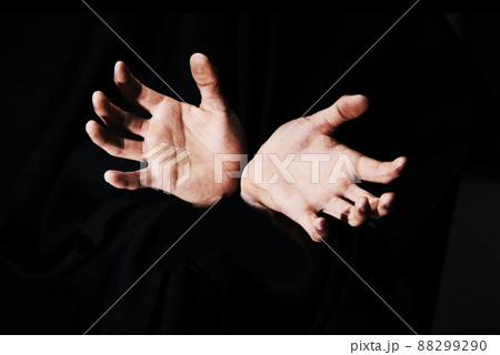 Theyre coming to grab you. Two hands isolated against a black background. Theyre coming to grab you. Two hands isolated against a black background. 88299290