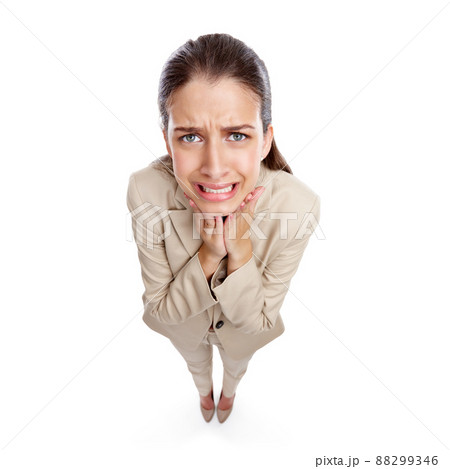 I wish I hadnt made that decision. High angle studio shot of a beautiful young businesswoman looking anxious against a white background. I wish I hadnt made that decision. High angle studio shot of a beautiful young businesswoman looking anxious against a white background. 88299346