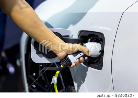 Hand holding Electric car charger.  88300307