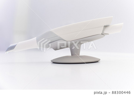 Dental intraoral scanner isolated on table in bright dentist office. Dentistry and health care concept. Close up. Dental intraoral scanner isolated on table in bright dentist office. Dentistry and health care concept. Close up. 88300446