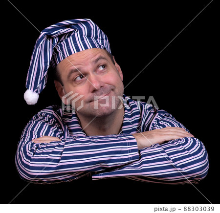 A happy man in pajamas on a black background A happy man in pajamas on a black background 88303039