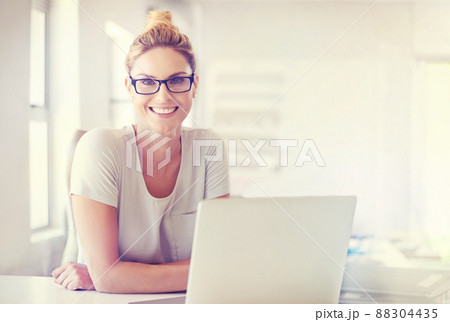 Career confidence. Portrait of a happy woman working at her desk in a casual office environment. 88304435