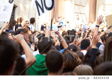 Power to the people. Rearview shot of a crowd protesting outside a public building. 88304436
