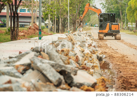 Drilling and demolishing the concrete pavement of the roadside pavement. Drilling into the pavement with a big truck is a very good machine. 88306214