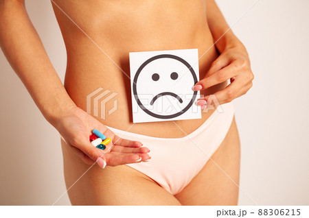 Woman Health, Female Body Holding Sad Smile Card Near Stomach. 88306215
