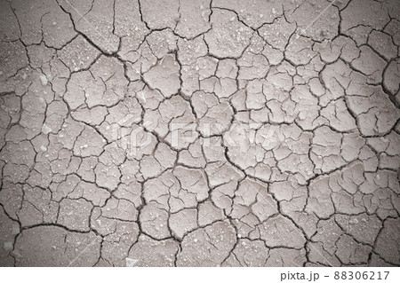 Full frame to terrain with arid climate. The surface of the land is cracked. crack soil ground texture. The natural texture of soil with cracks. Broken clay surface of barren dryland wasteland closeup 88306217