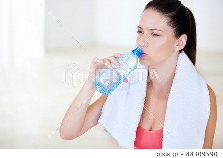 Its important to drink enough water. Young woman drinking water after a gym session. Its important to drink enough water. Young woman drinking water after a gym session. 88309590