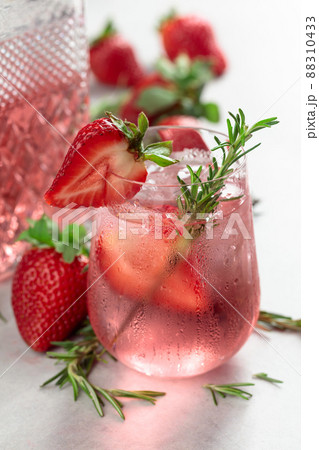 Refreshing drink with natural ice, strawberries, and rosemary. 88310433