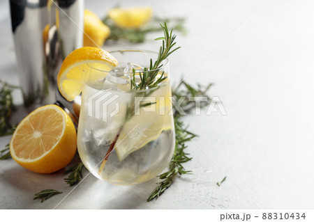 Refreshing drink with natural ice, lemon, and rosemary. 88310434