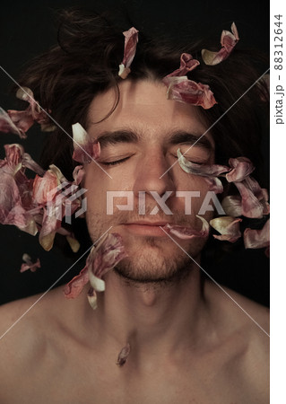 the face of a man in which the petals of flowers flew eyes closed the face of a man in which the petals of flowers flew eyes closed 88312644