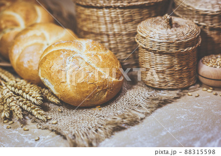Fresh bread and wheat on a rustic background 88315598