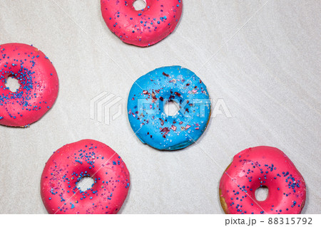 Delicious glazed donuts with sprinkles on light background Delicious glazed donuts with sprinkles on light background 88315792