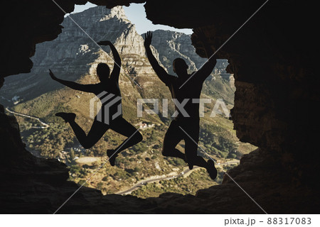 We did it. Rearview shot of a young couple jumping in excitement while hiking in the mountains. We did it. Rearview shot of a young couple jumping in excitement while hiking in the mountains. 88317083