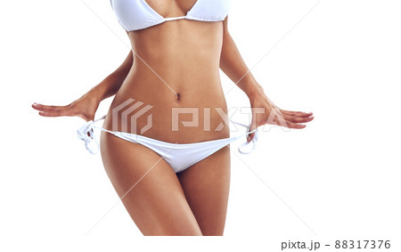 Bikini season is here. Cropped studio shot of a woman in a bikini isolated on white. Bikini season is here. Cropped studio shot of a woman in a bikini isolated on white. 88317376