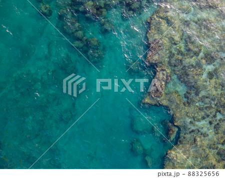 晴れた日の沖縄県島尻郡八重瀬町の透き通る海の干潮時の干潟の空からの写真 晴れた日の沖縄県島尻郡八重瀬町の透き通る海の干潮時の干潟の空からの写真 88325656