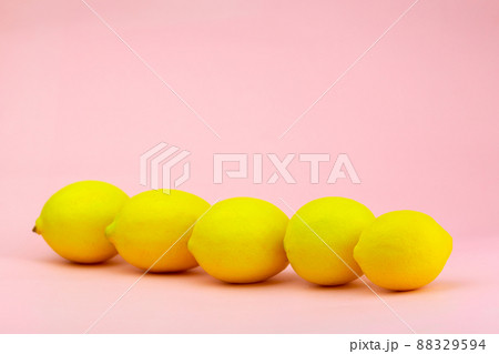 Lemons laid diagonally on a pink background Lemons laid diagonally on a pink background 88329594