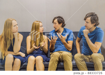 Young couple swears on the couch. SEMI TRANSPARENT Watch and evaluate their behavior from the side. Emotional intelligence concept 88333726