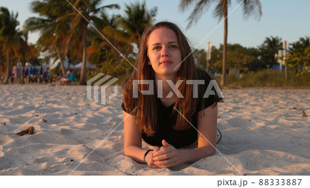 Woman relaxes at the beach of Miami at sunset - beautiful silhouette shot 88333887