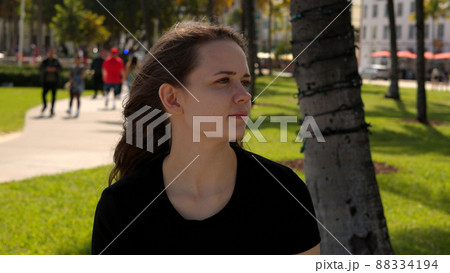 Young woman relaxes in the sun at the promenade of Miami South Beach Young woman relaxes in the sun at the promenade of Miami South Beach 88334194