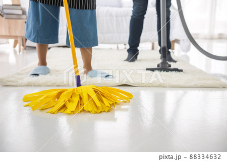 mop and vacuum cleaner on carpet and floor in white bedroom mop and vacuum cleaner on carpet and floor in white bedroom 88334632