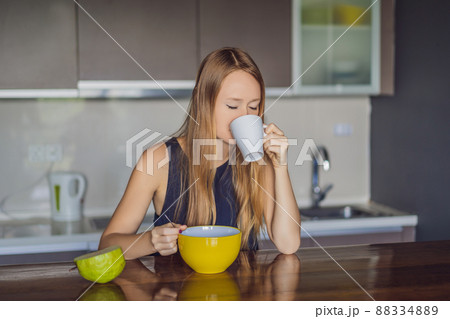 Beautiful woman having coffee and fruits for breakfast 88334889