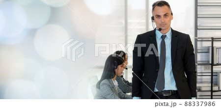 Business people wearing headset working in office broaden view Business people wearing headset working in office broaden view 88337986