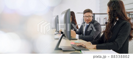 Business people wearing headset working in office broaden view Business people wearing headset working in office broaden view 88338802