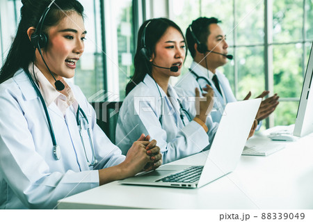 Doctor team wearing headset talking actively on video call in hospital clinic 88339049