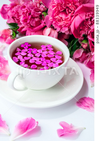 Creative layout with pink peonies flowers and cup of tea on bright table. Spring Seasonal valentine, woman, mother, 8 march holiday, romance breakfast. Stylish blogger. Greeting card 88339949