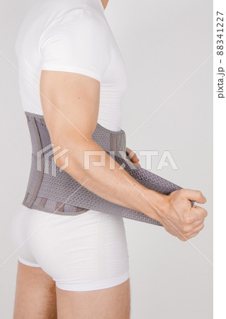 Lumbar brace on the human body isolated on a white background