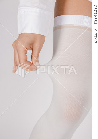 Anti-embolic Compression Hosiery for surgery isolated on white. Medical white stockings, tights for varicose veins and venouse therapy. Thrombo embolic deterrent hose or anti-embolism stockings. Anti-embolic Compression Hosiery for surgery isolated on white. Medical white stockings, tights for varicose veins and venouse therapy. Thrombo embolic deterrent hose or anti-embolism stockings. 88341233