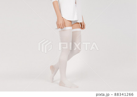 Anti-embolic Compression Hosiery for surgery isolated on white. Medical white stockings, tights for varicose veins and venouse therapy. Thrombo embolic deterrent hose or anti-embolism stockings. 88341266