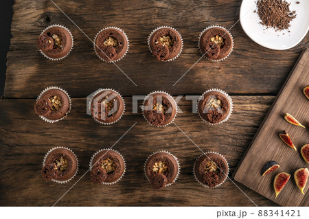 Process of making cupcakes. Ingredients for making muffins. Chocolate muffins with nut filling. Top view. 88341421