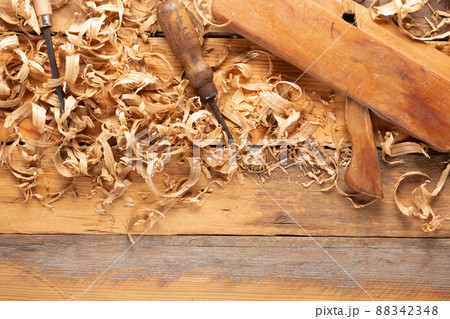Plane jointer carpenter or joiner tool and wood shavings. Woodworking tools at wooden table 88342348