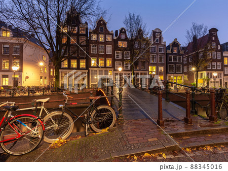 Beautiful old houses on the city waterfront of Amsterdam at sunset. 88345016