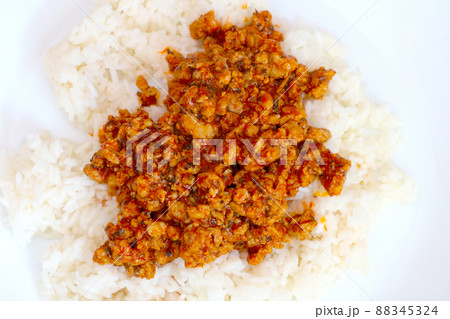 White plate with rice and cooked minced meat. 88345324
