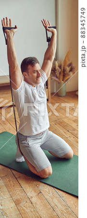 Man exercising during online video workout from home 88345749