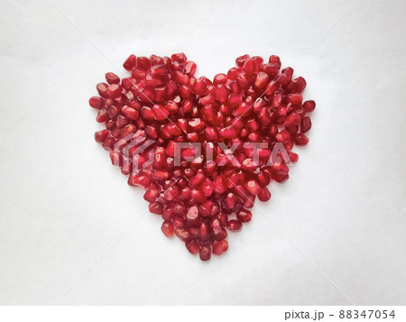 Heart from pomegranate seeds isolated on white background. Heart shape. Heart from pomegranate seeds isolated on white background. Heart shape. 88347054