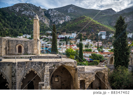 View of Bellapais Abbey with village on the background. Kyrenia district, Cyprus 88347402